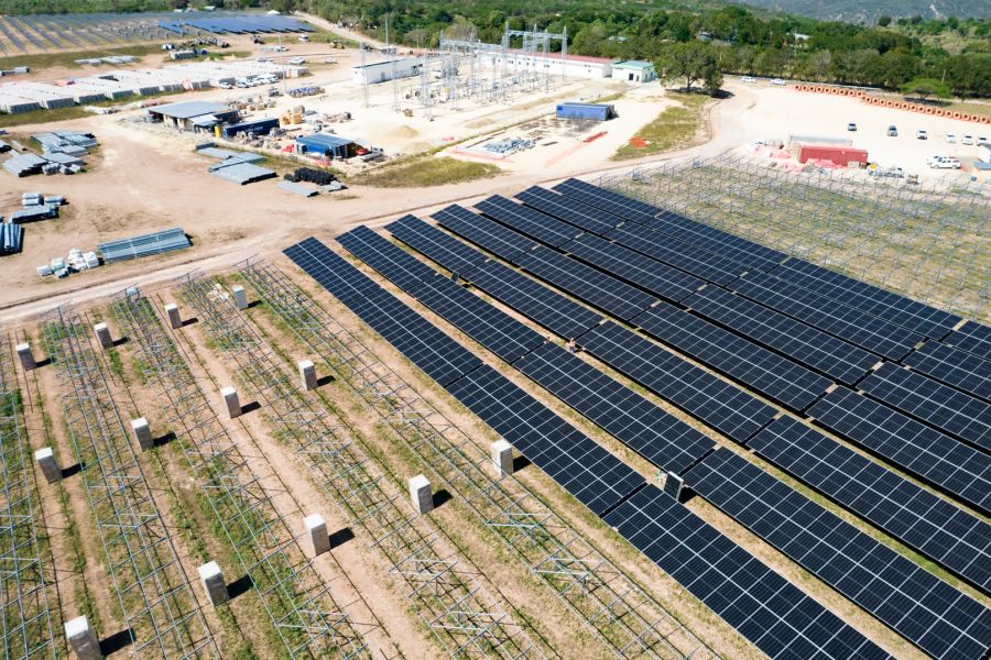 Technicians installing solar modules on an industrial roof